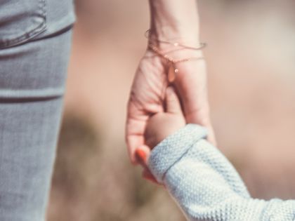 child in adult hand.jpg